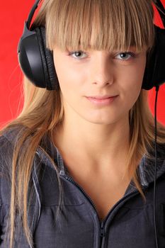 Young beautiful happy women listening music in headphones