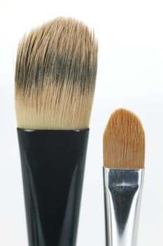 Makeup brushes isolated against a white background