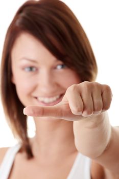 Casual woman smiling with her thumbs making decision - isolated