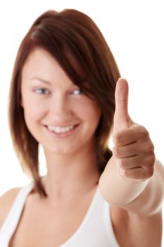 Casual woman smiling with her thumbs up - isolated