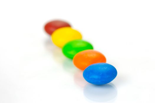 Chocolate coated candy isolated against a white background