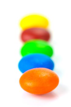 Chocolate coated candy isolated against a white background