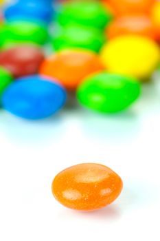 Chocolate coated candy isolated against a white background