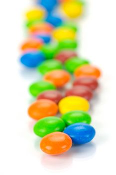 Chocolate coated candy isolated against a white background