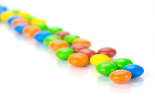 Chocolate coated candy isolated against a white background