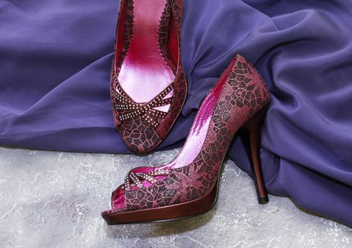 Female shoes and violet silk dress