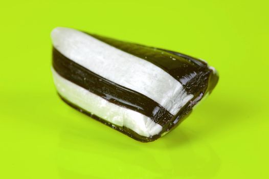 Humbug lollies isolated against a yellow background