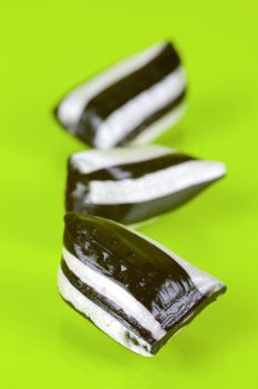 Humbug lollies isolated against a yellow background