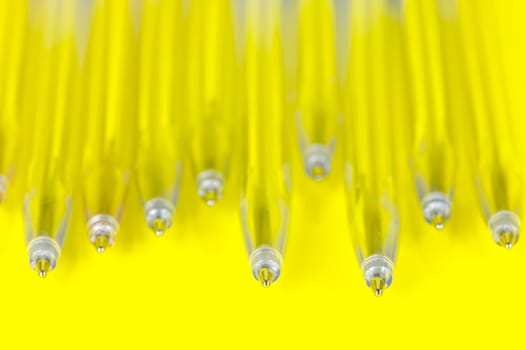 Ball point pens isolated against a yellow background