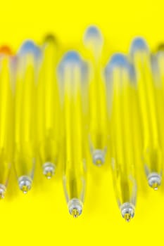 Ball point pens isolated against a yellow background