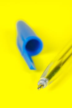 Ball point pens isolated against a yellow background