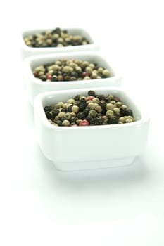 A close up shot of mixed pepper corns mixed together