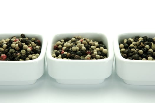 A close up shot of mixed pepper corns mixed together