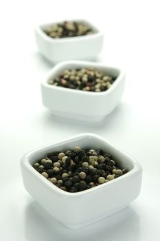 A close up shot of mixed pepper corns mixed together