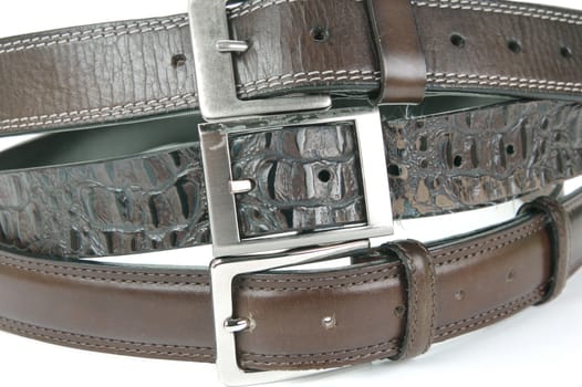 Brown belts isolated against a white background