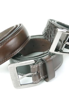 Brown belts isolated against a white background