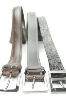 Brown belts isolated against a white background