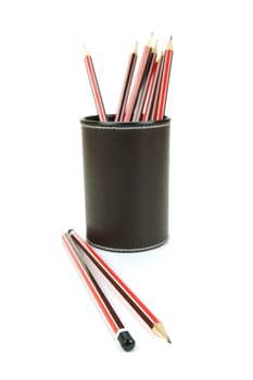 Lead pencils in a cup holder isolated against a white background