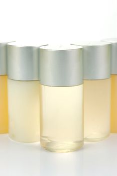 Miniatureshampoo bottles isolated against a white background