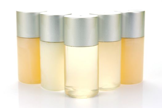 Miniatureshampoo bottles isolated against a white background