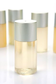Miniatureshampoo bottles isolated against a white background