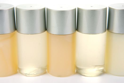 Miniatureshampoo bottles isolated against a white background
