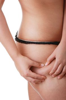 Woman pinching leg for skin fold test isolated on white background
