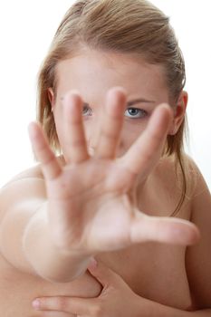 Scared nude woman defend herself from somebody striking out at her - fear concept
