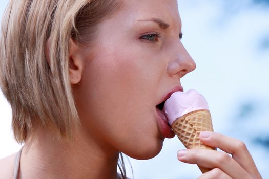 Portrait of young happy woman eating ice-cream, outdoor