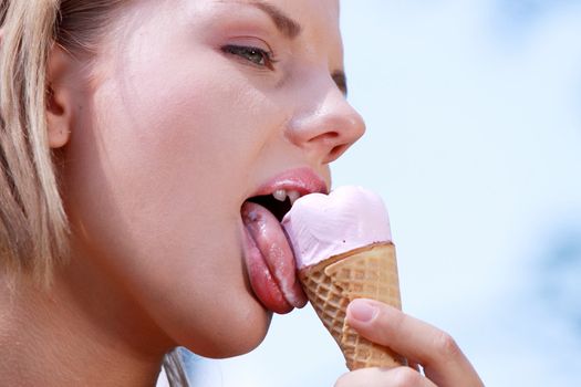 Portrait of young happy woman eating ice-cream, outdoor