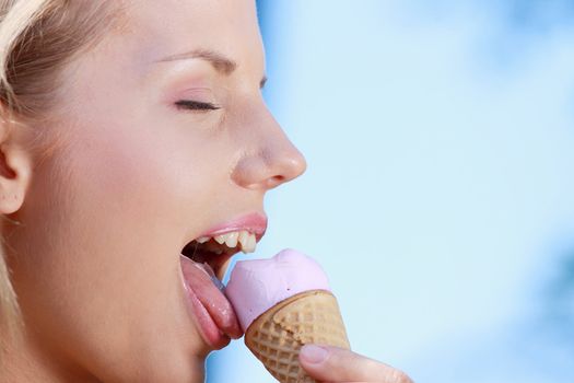 Portrait of young happy woman eating ice-cream, outdoor
