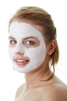 Cosmetics mask of clay on the young female face