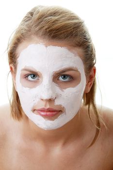 Cosmetics mask of clay on the young female face