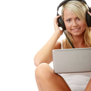 Casual student listening to music on the computer while studying isolated over a white background