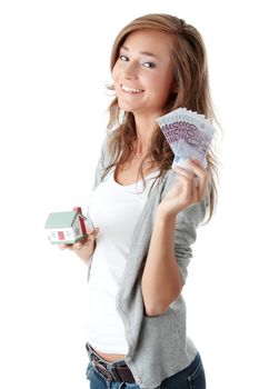 Beautiful young woman holding euros bills and house model over white - real estate loan concept