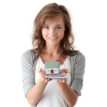 Beautiful young woman holding euros bills and house model over white - real estate loan concept