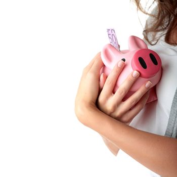 Young beautiful woman standing with piggy bank (money box), isolated on white background