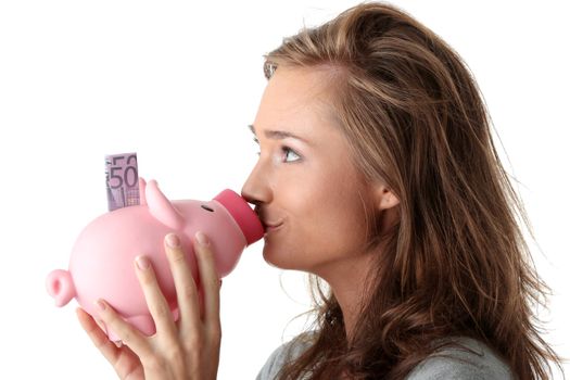 Young beautiful woman standing with piggy bank (money box), isolated on white background