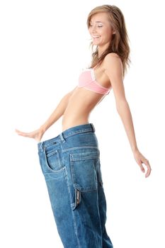 Woman showing how much weight she lost. Isolated