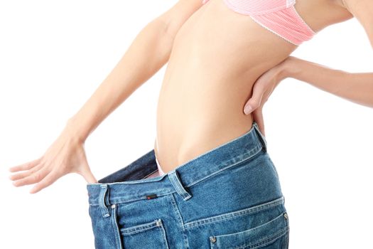 Woman showing how much weight she lost. Isolated