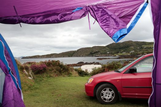 car and tent at campsite on the edge of the coast of kerry in ireland