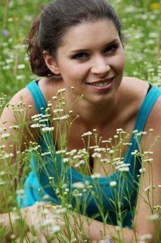 Beautiful young woman relaxing in the grass