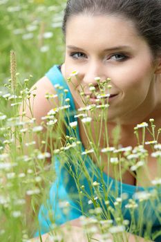 Beautiful young woman relaxing in the grass