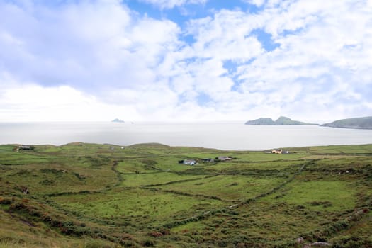 scenic view in kerry ireland of fields coastline and skellig rock