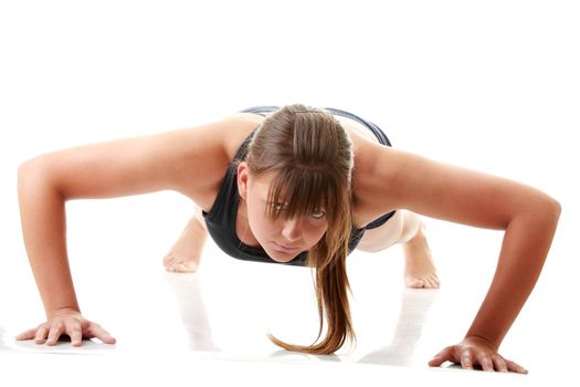 Relaxed fit woman doing exercise, isolated on white background.