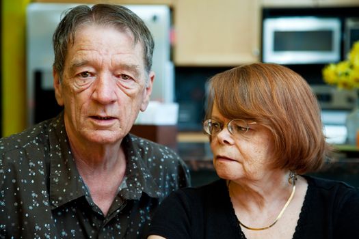 Worried Senior Couple at Home in Modern  Kitchen