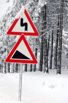 Traffic road sign in frost and snow