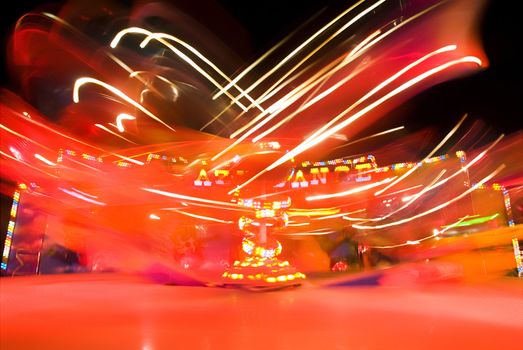 Blur neon lights in amusement park, long exposure