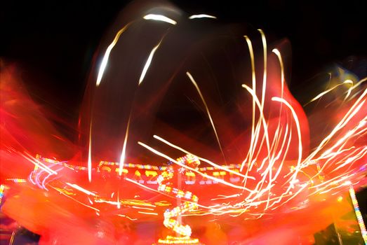 Blur neon lights in amusement park, long exposure