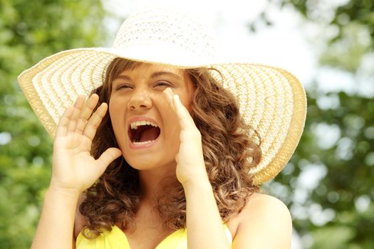Young woman screaming in country side